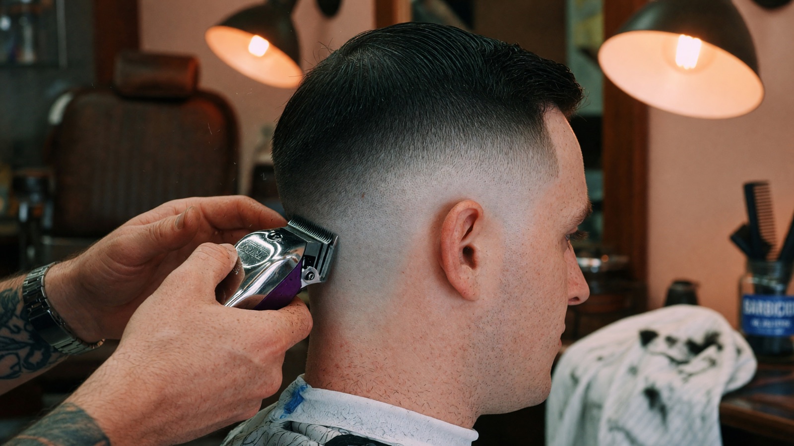 A Berea barber blending a clean skin fade with clippers at The Twisted Willow Barbershop