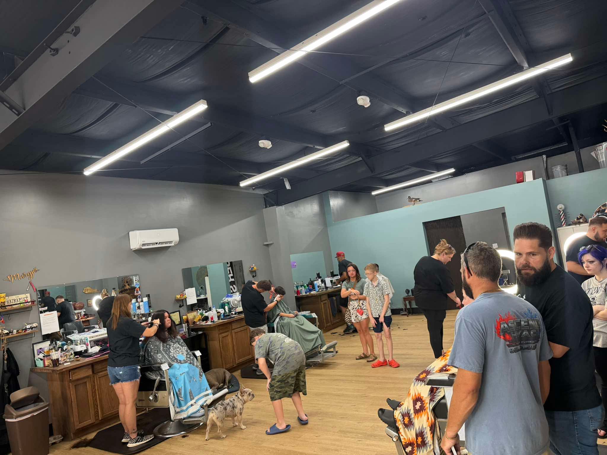 The Twisted Willow Barbershop filled with families and barbers during Community Care Day 2026
